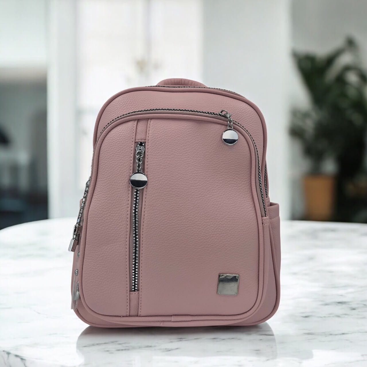 Dusty rose pebbled faux leather mini backpack, front vertical zip pocket and top handle
